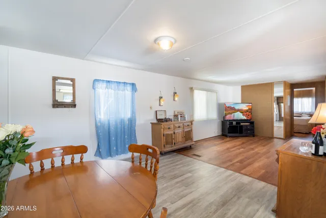a living room with furniture dining table and wooden floor
