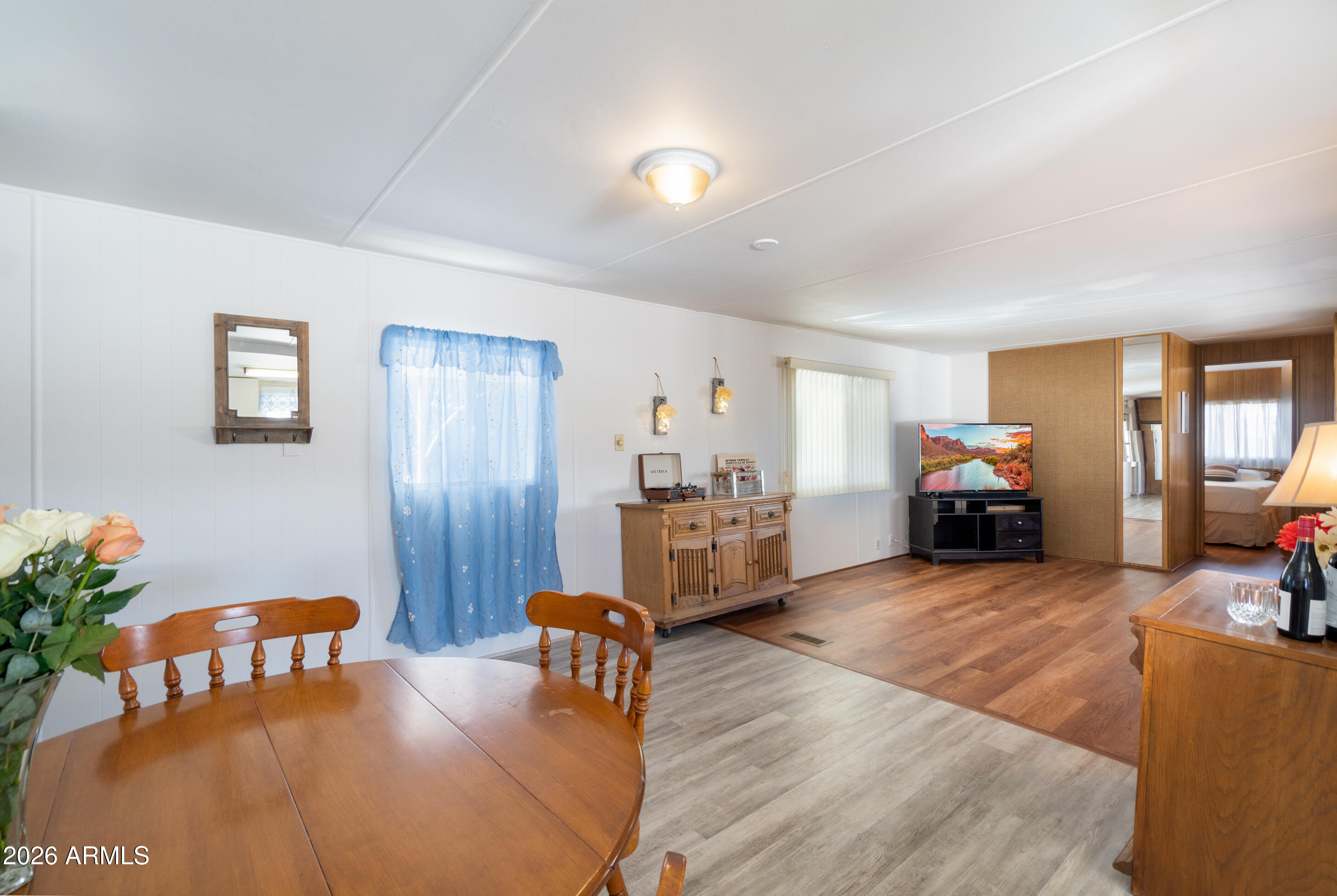 201 South Greenfield Road, Unit 361 Mesa, AZ 85206 - Photo 24 of 53 a living room with furniture and a dining table with bookshelf