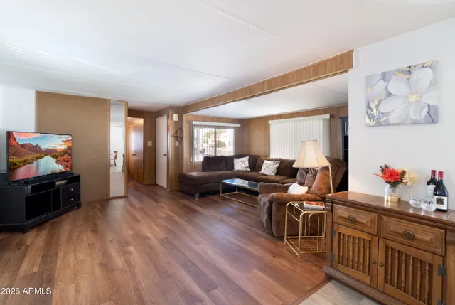 a living room with furniture and wooden floor