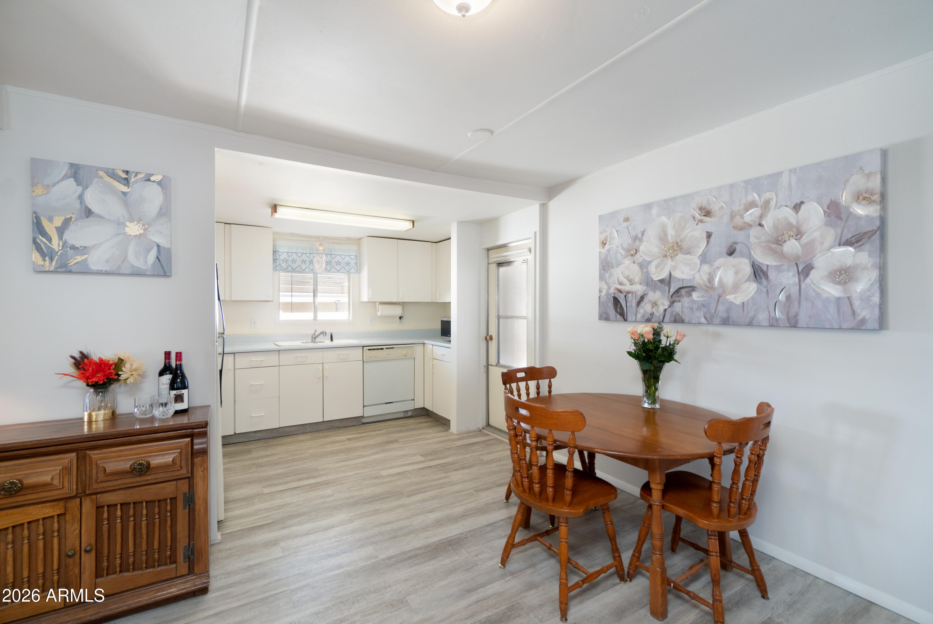 201 South Greenfield Road, Unit 361 Mesa, AZ 85206 - Photo 29 of 53 a view of a dining room with furniture and wooden floor
