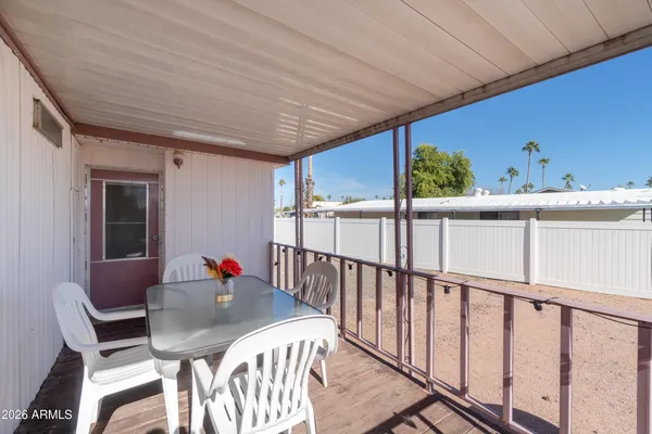 a view of balcony with table and chairs