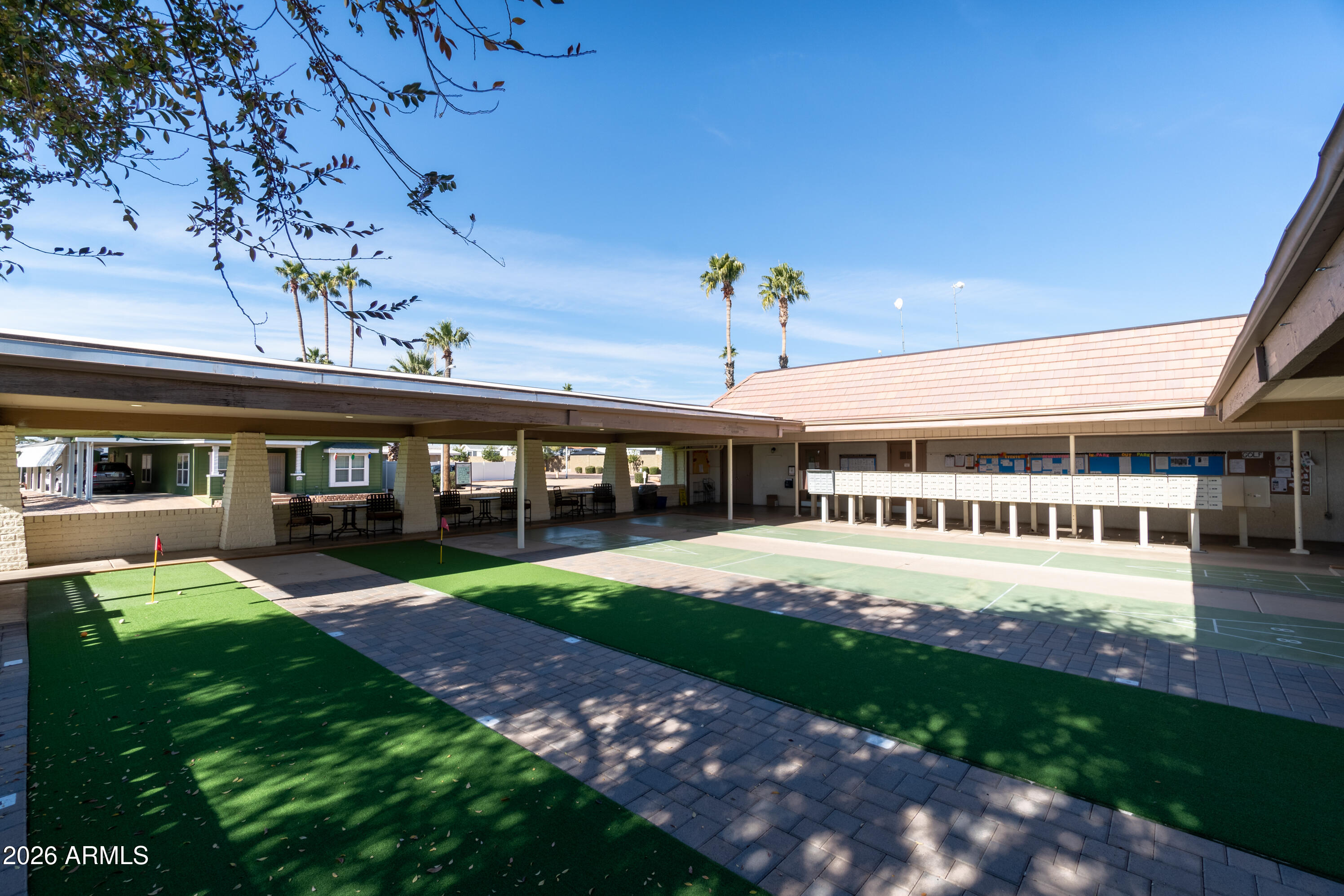 201 South Greenfield Road, Unit 361 Mesa, AZ 85206 - Photo 40 of 53 a view of a patio with a table and chairs under an umbrella