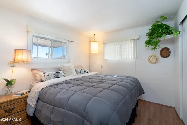 a bedroom with a bed and a potted plant