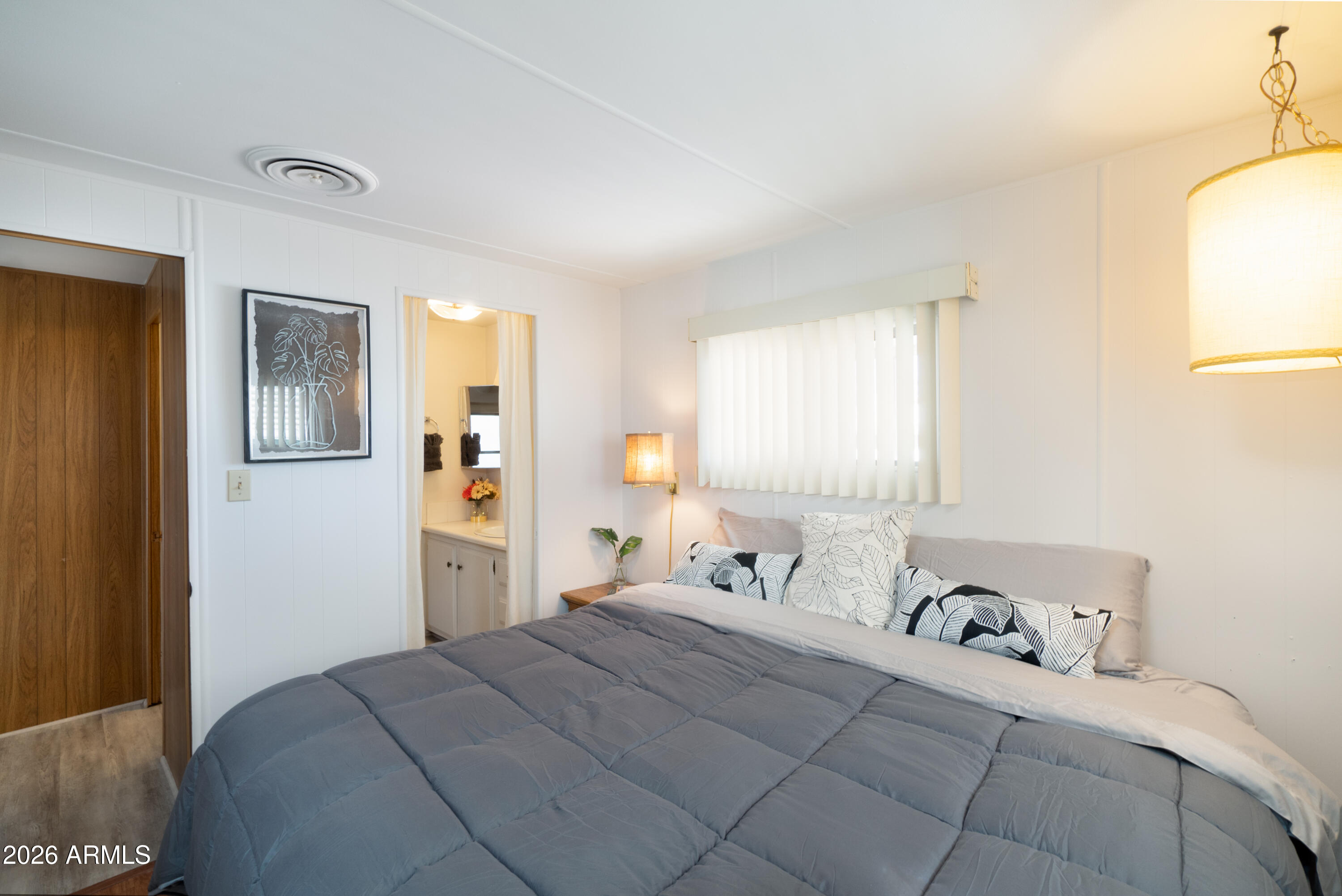 201 South Greenfield Road, Unit 361 Mesa, AZ 85206 - Photo 8 of 53 a bedroom with a bed and wooden floor