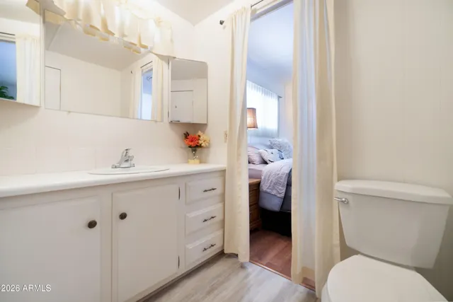 a en suite bathroom with a sink a toilet and a mirror