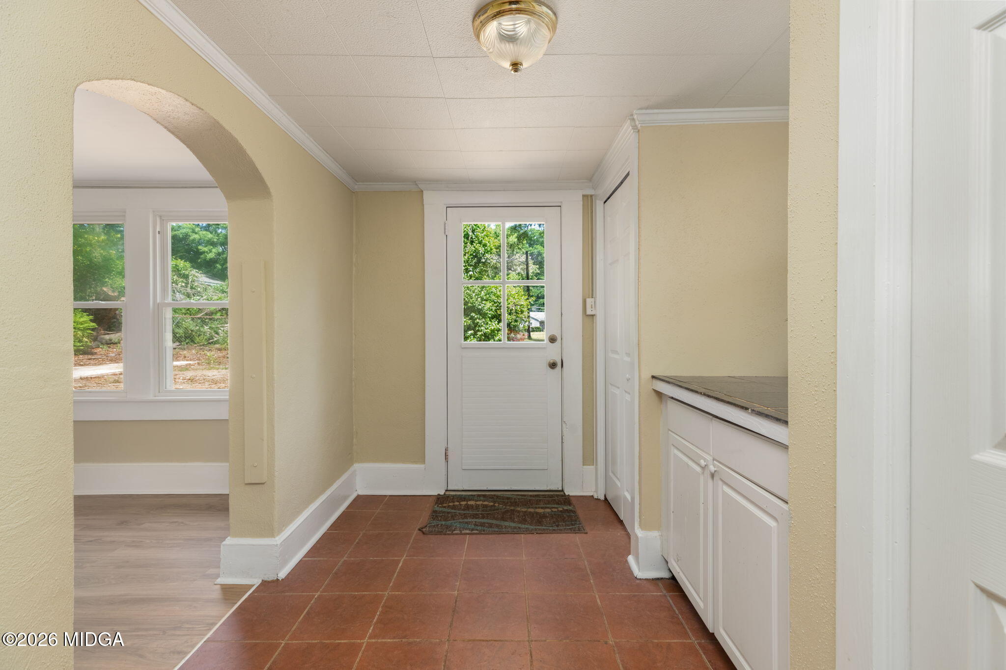 107 Childs Street Gray, GA 31032 - Photo 11 of 37 a view of a hallway to an entryway with wooden floor and windows