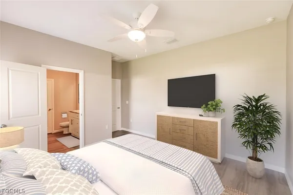 a bedroom with a bed and a flat screen tv