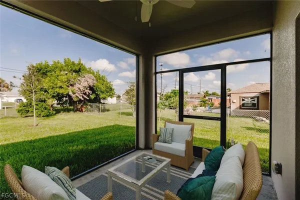a view of a porch with furniture and garden