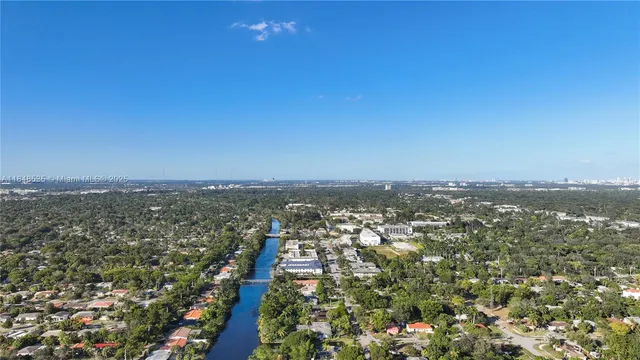 an aerial view of residential building and trees around