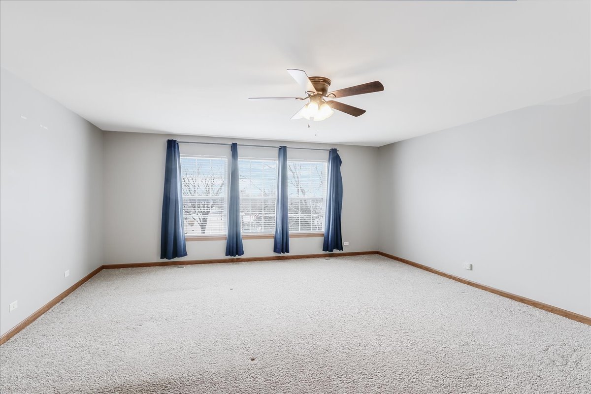 600 Spring Drive Marengo, IL 60152 - Photo 16 of 28 an empty room with windows and fan