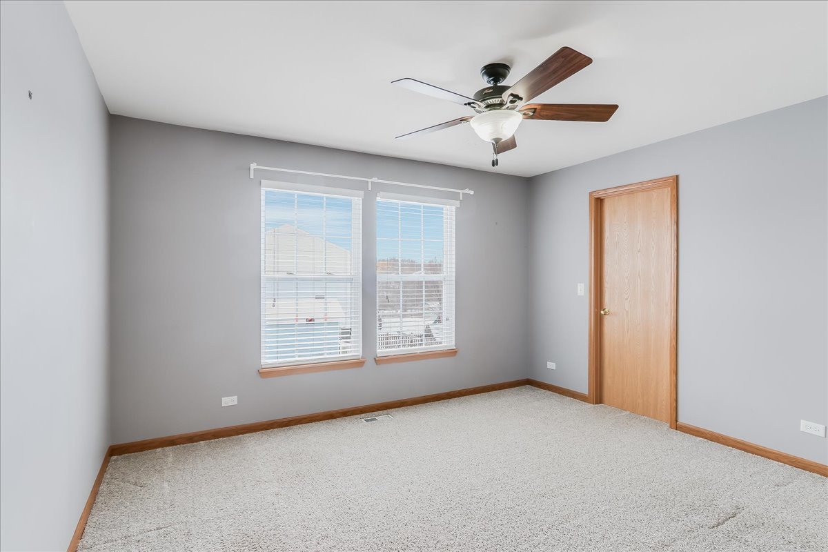 600 Spring Drive Marengo, IL 60152 - Photo 21 of 28 an empty room with window and ceiling fan