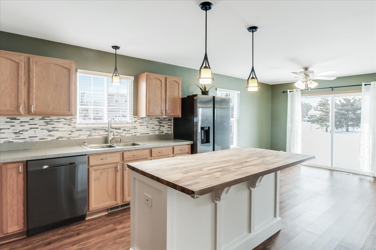 600 Spring Drive Marengo, IL 60152 - Photo 5 of 28 a kitchen with refrigerator and wooden floor