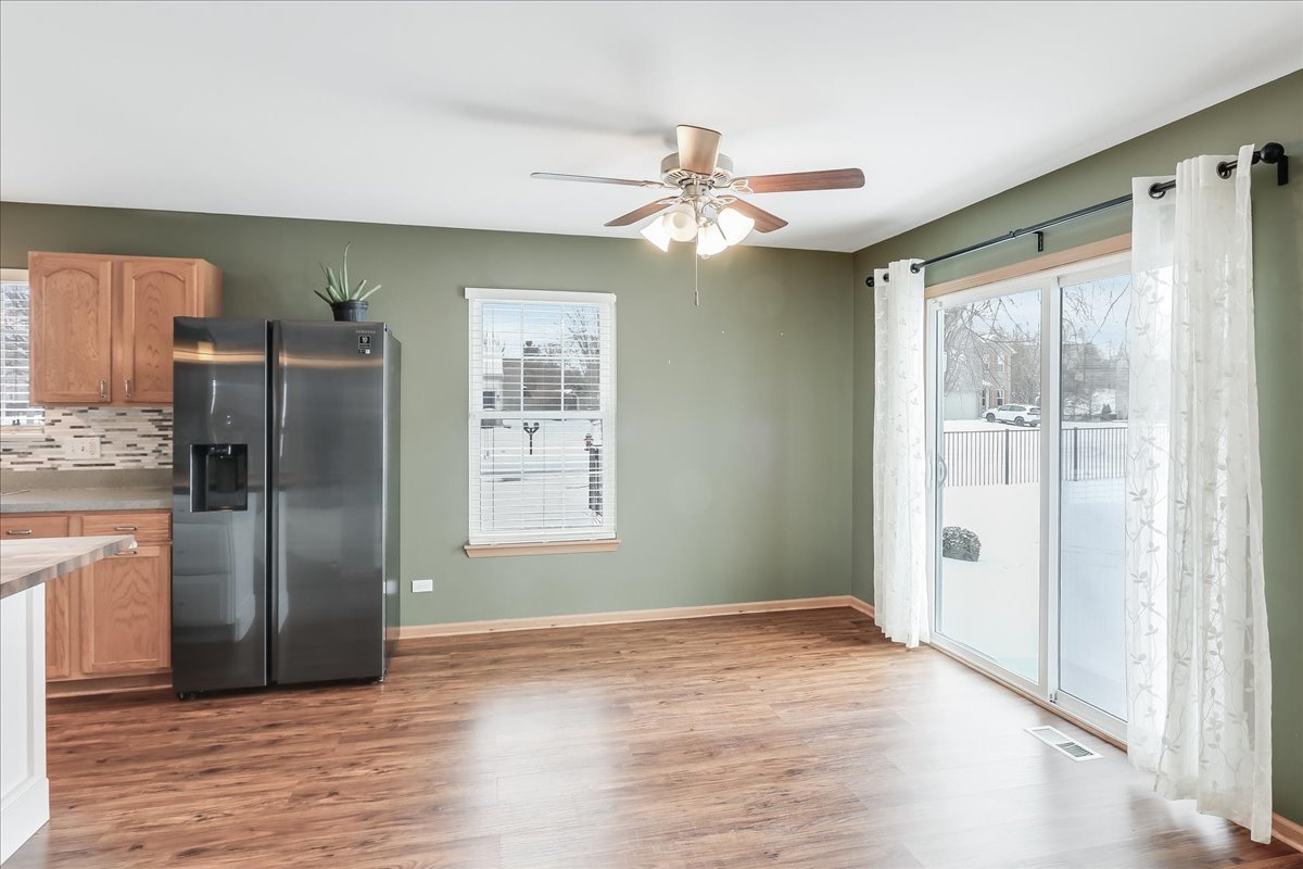 600 Spring Drive Marengo, IL 60152 - Photo 7 of 28 a view of an empty room with wooden floor and a kitchen