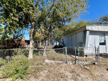 a backyard of a house with table and chairs