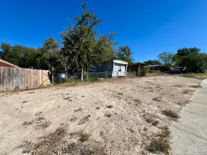 a backyard of a house with large trees