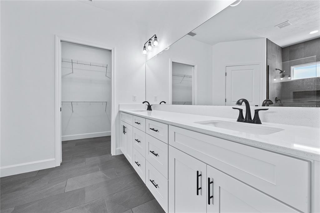 6726 Southwest 10th Lane Gainesville, FL 32607 - Photo 11 of 29 a bathroom with a double vanity sink and mirror