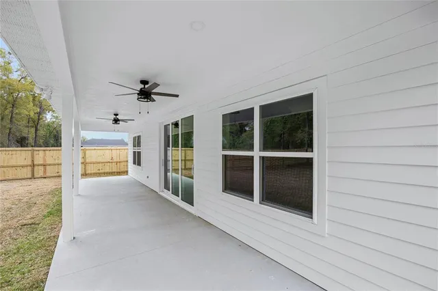 a view of a porch with wooden floor and a floor to ceiling window