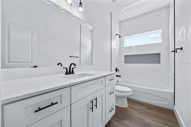 a bathroom with a double vanity sink toilet and shower