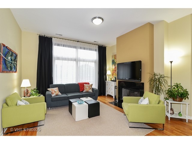 2089 West Wabansia Avenue, Unit 306 Chicago, IL 60647 - Photo 2 of 12 a living room with furniture and a flat screen tv