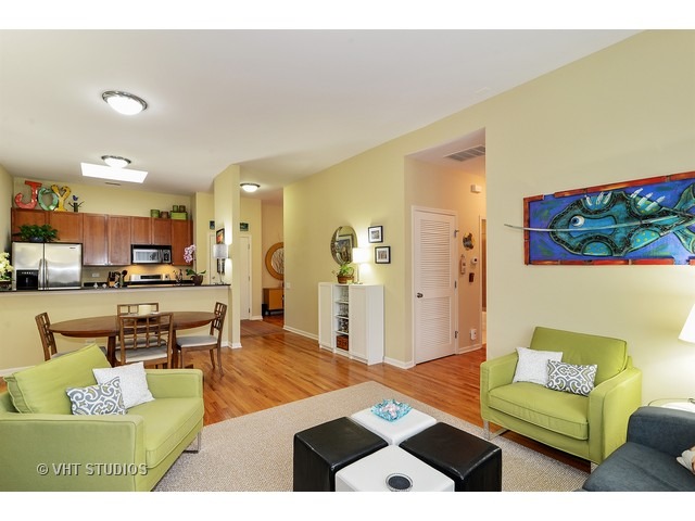 2089 West Wabansia Avenue, Unit 306 Chicago, IL 60647 - Photo 5 of 12 a living room with furniture and a dining table with kitchen view