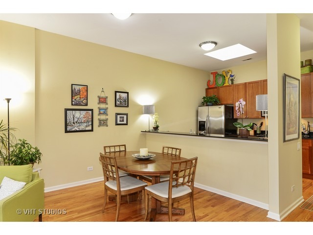 2089 West Wabansia Avenue, Unit 306 Chicago, IL 60647 - Photo 6 of 12 a view of a dining room with furniture and a potted plant