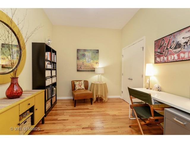 2089 West Wabansia Avenue, Unit 306 Chicago, IL 60647 - Photo 7 of 12 a living room with furniture and a wooden floor