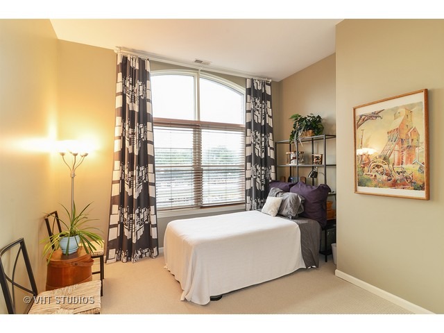 2089 West Wabansia Avenue, Unit 306 Chicago, IL 60647 - Photo 10 of 12 a living room with furniture and a large window