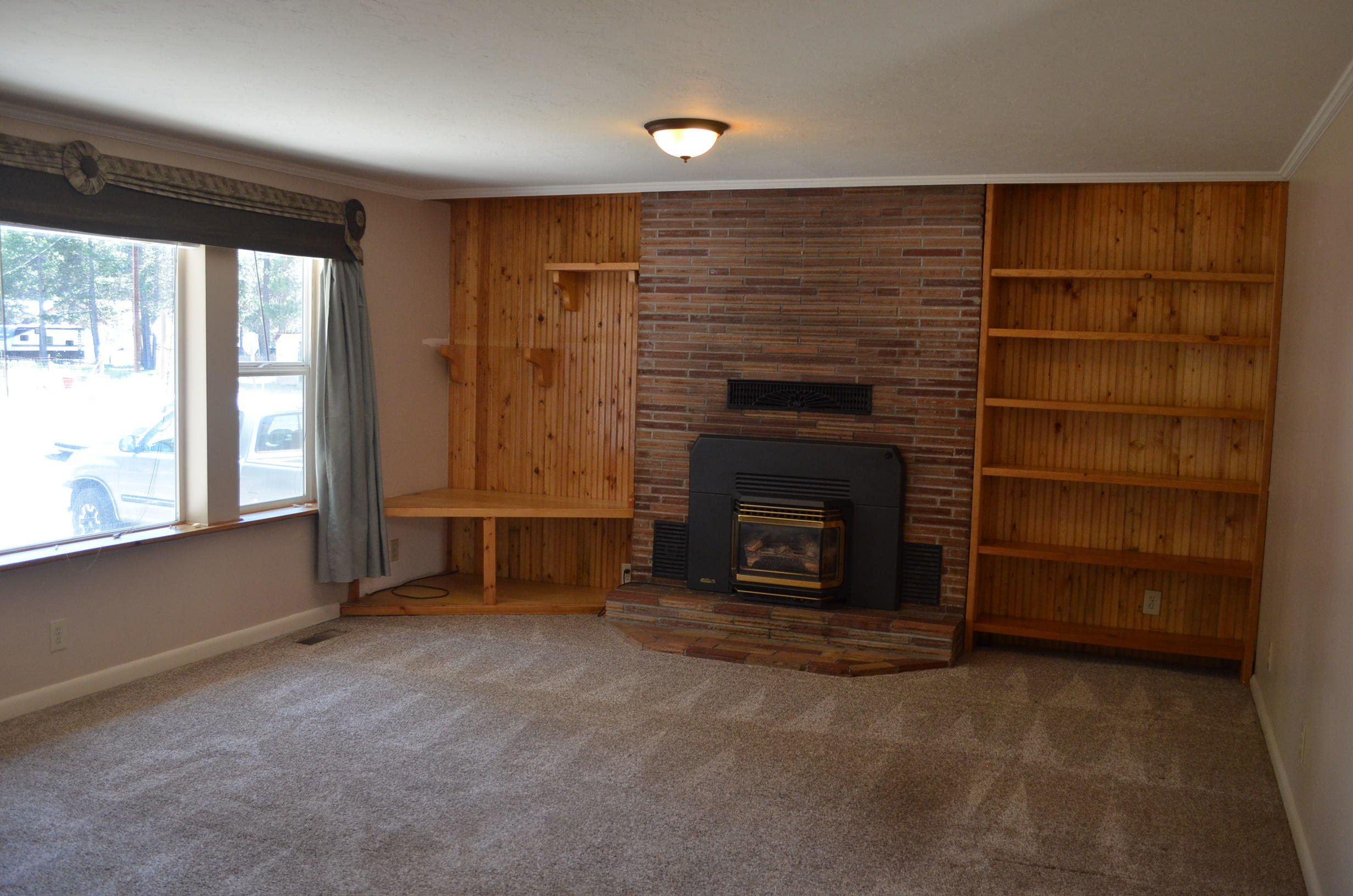 137008 Main Street Crescent, OR 97733 - Photo 5 of 50 a view of an empty room with a fireplace and a window