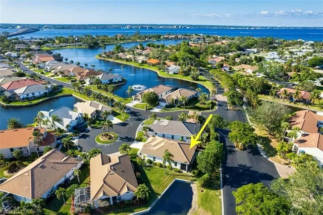 an aerial view of residential houses with outdoor space and river view