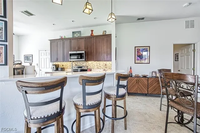 a kitchen with a dining table and chairs
