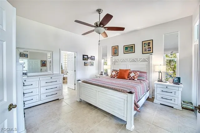 a bed room with a bed and a ceiling fan