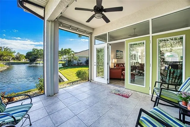 a view of a porch with furniture and a yard
