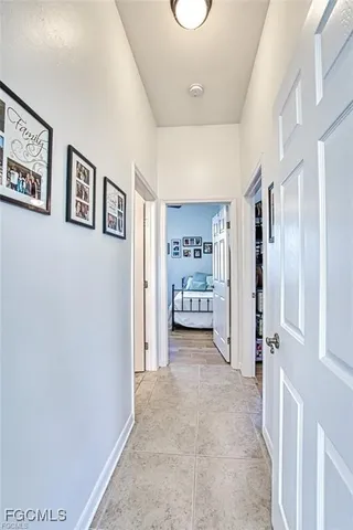 a view of a hallway with cabinet and bathroom