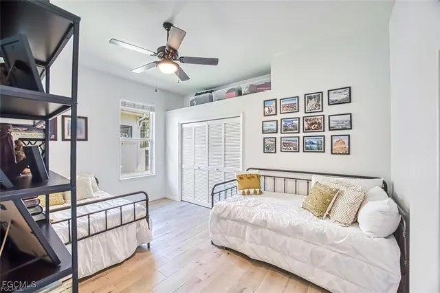 a spacious bedroom with a bed and wooden floor