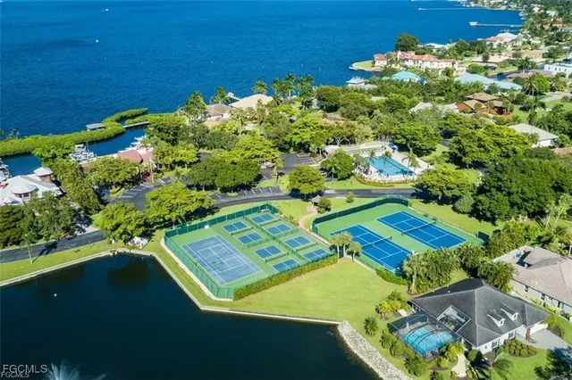 an aerial view of a residential houses with outdoor space and street view