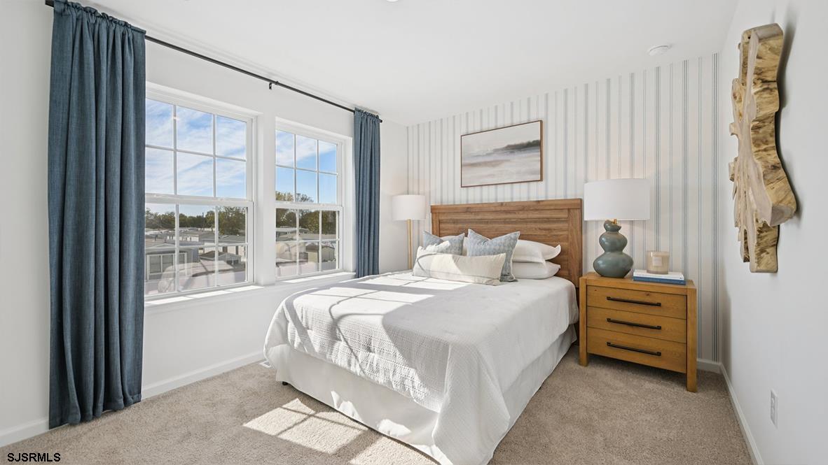 504 Scotty Boulevard, Unit 1203 Rio Grande, NJ 08242 - Photo 36 of 40 a bedroom with a bed a mirror and a window