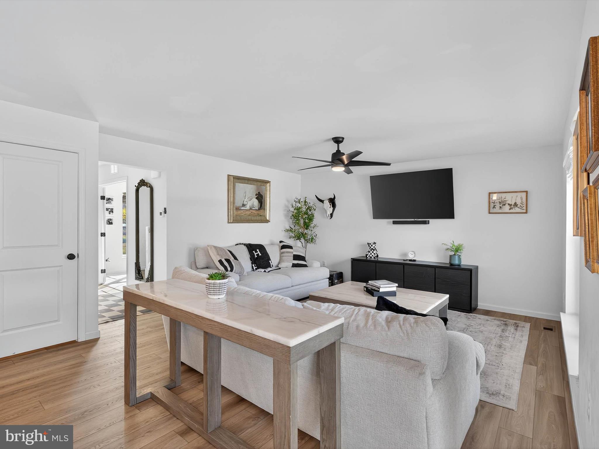 29 Ladderback Lane Reading, PA 19606 - Photo 12 of 60 a living room with furniture a flat screen tv and a refrigerator