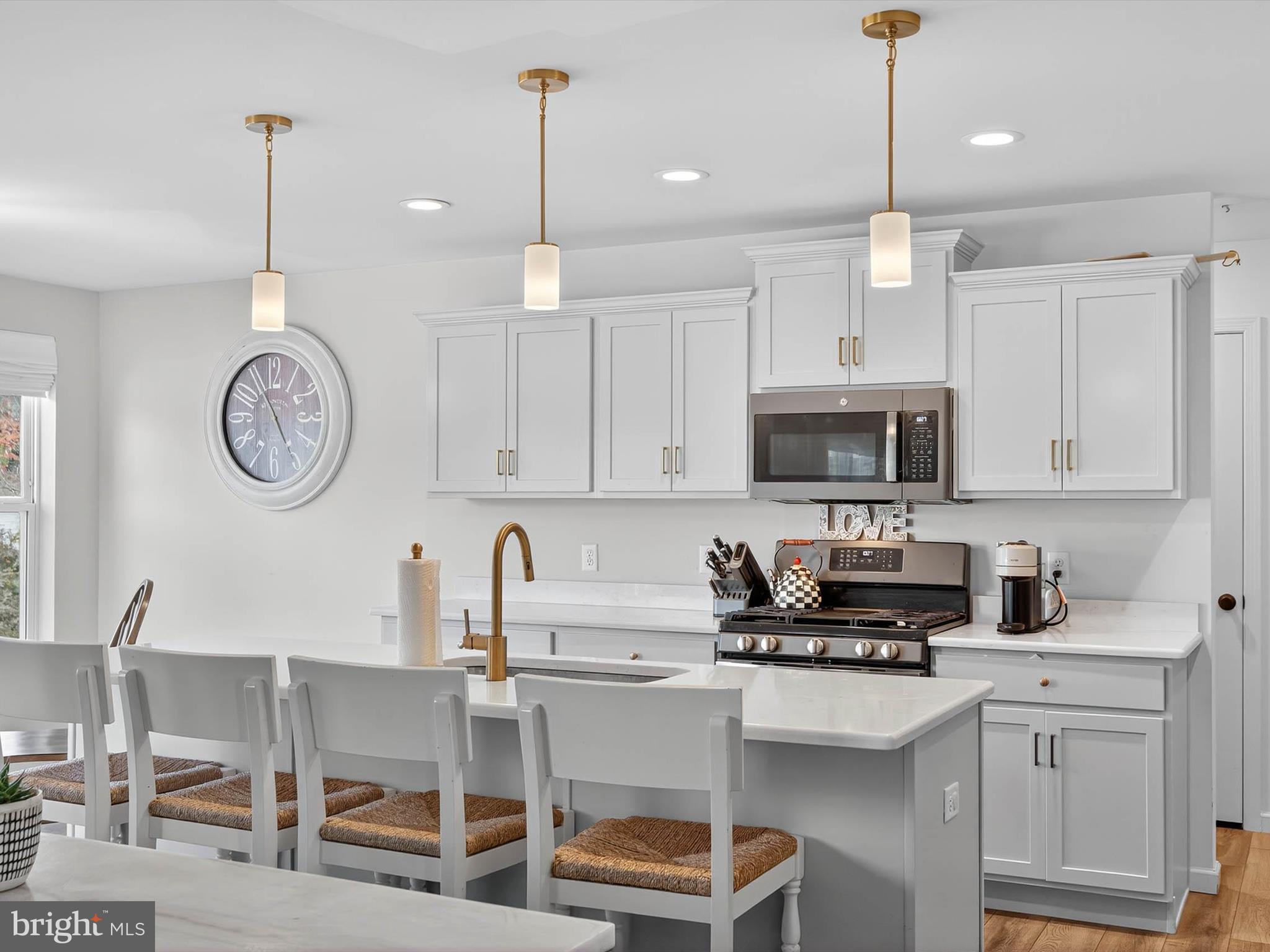 29 Ladderback Lane Reading, PA 19606 - Photo 14 of 60 a kitchen with stainless steel appliances a stove a sink cabinets and a dining table with chairs