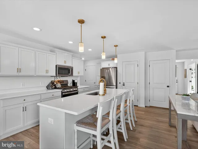 a kitchen with sink a stove and refrigerator