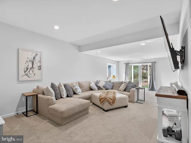 a living room with furniture and a mirror