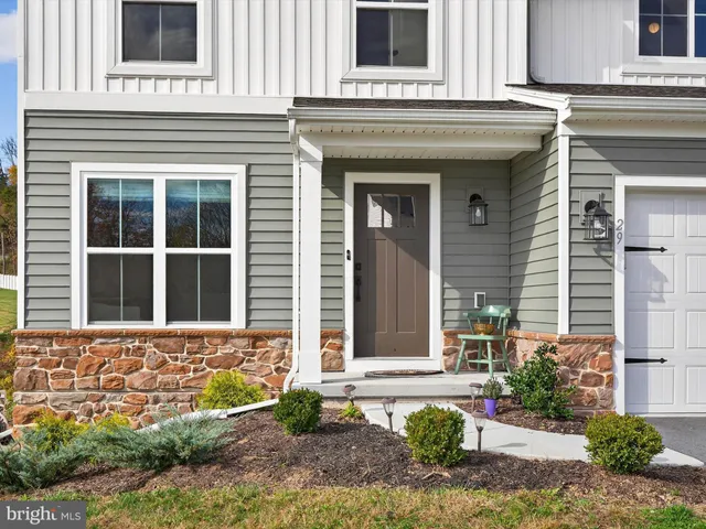 a view of a livingroom with a dining area wooden floor and a window