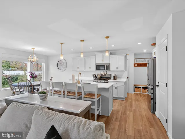 a living room with furniture and a view of kitchen