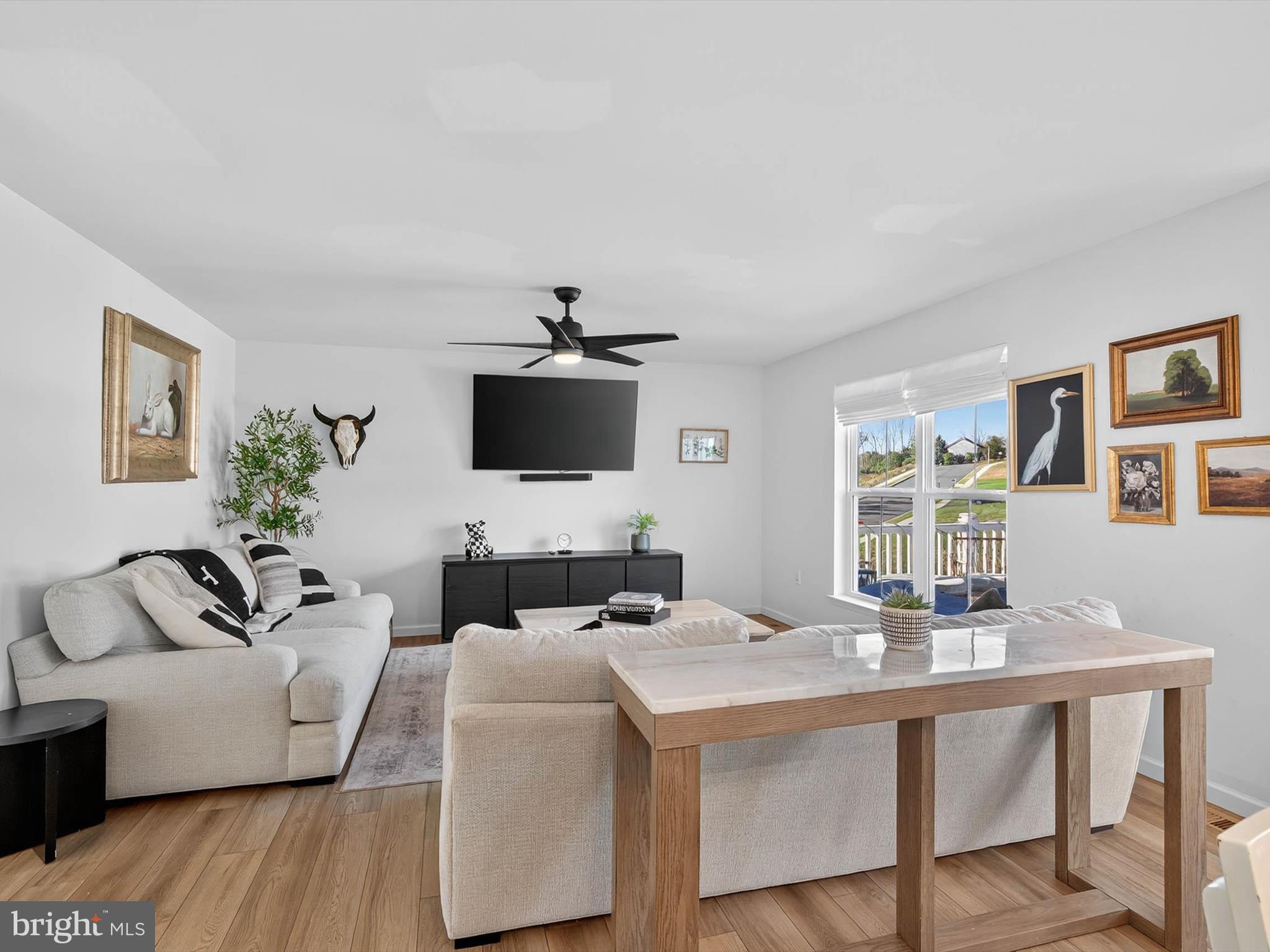 29 Ladderback Lane Reading, PA 19606 - Photo 7 of 60 a living room with furniture a flat screen tv and a table
