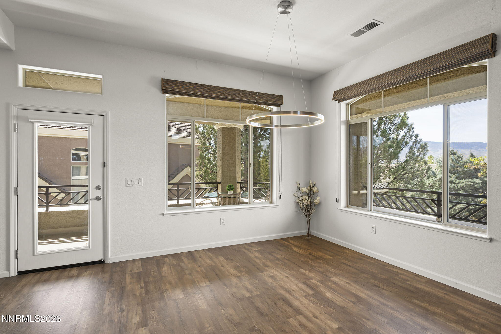 9900 Wilbur May Parkway, Unit 304 Reno, NV 89521 - Photo 16 of 47 a view of an empty room with a window and wooden floor