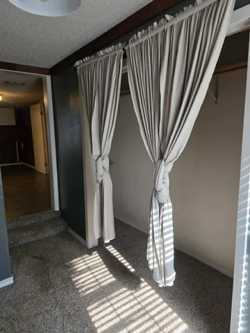 a kitchen with wooden floors and white cabinets