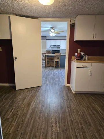 a view of closet and wooden floor