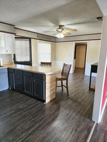 a view of a kitchen wooden floor and a living room