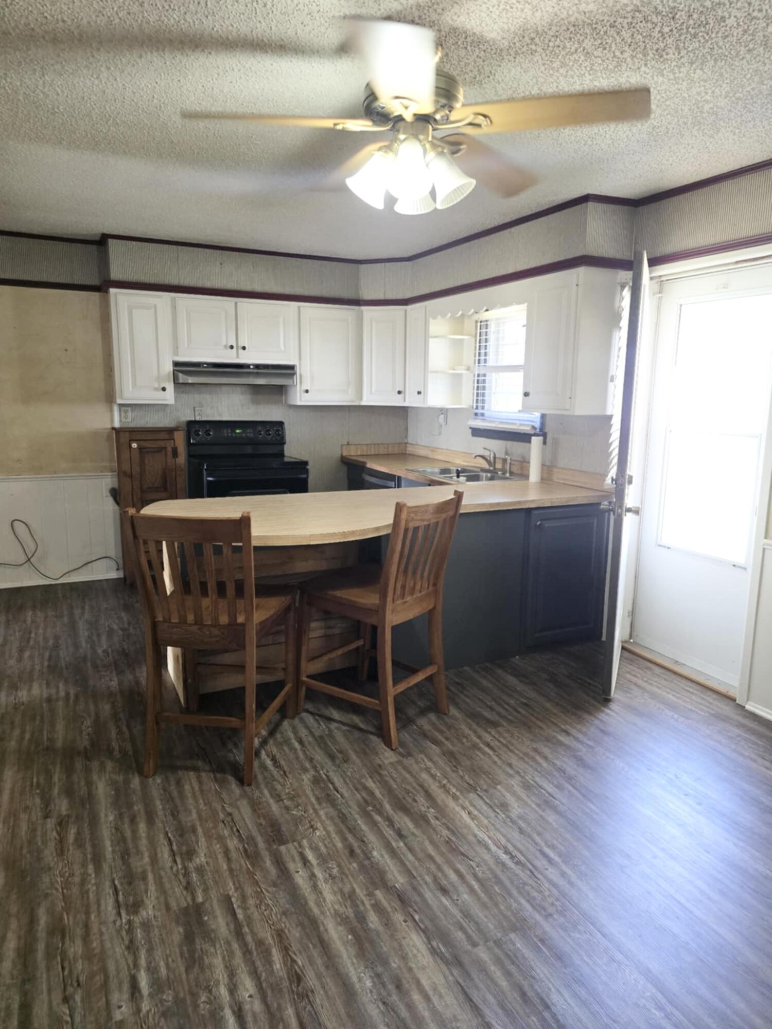 640 Fm 168 Olton, TX 79064 - Photo 7 of 30 a kitchen with a table chairs and wooden floor