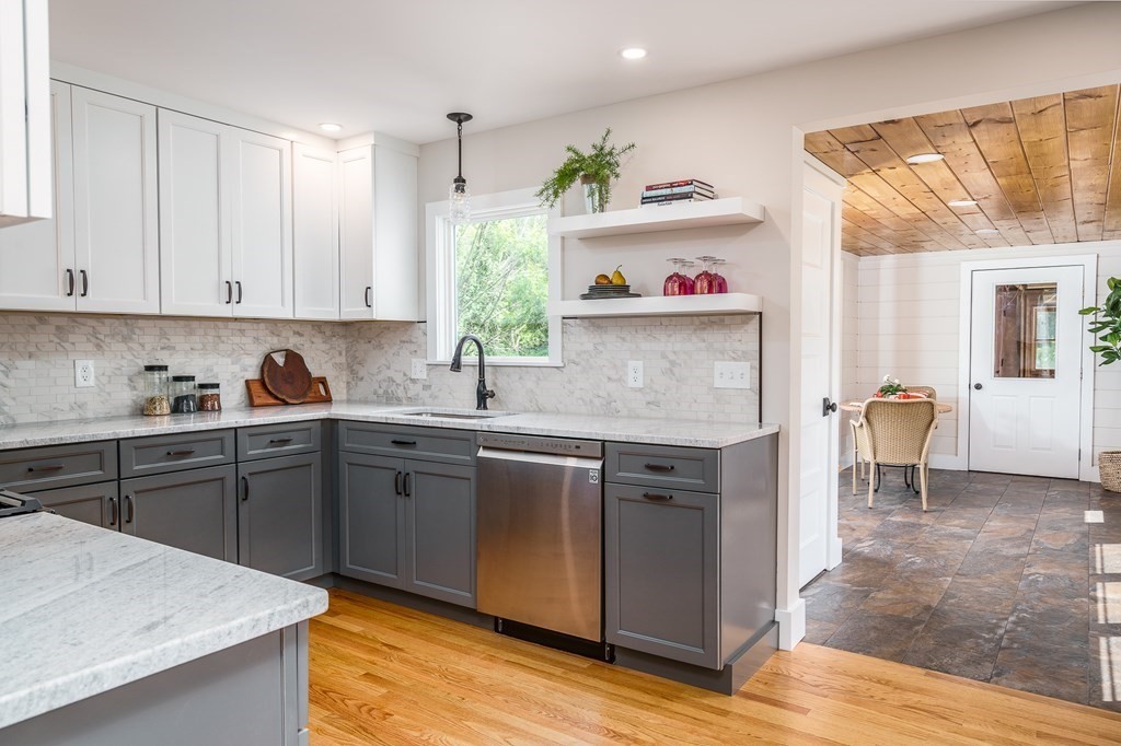 69 High Street Southampton, MA 01073 - Photo 15 of 42 a kitchen with stainless steel appliances granite countertop a sink stove and white cabinets