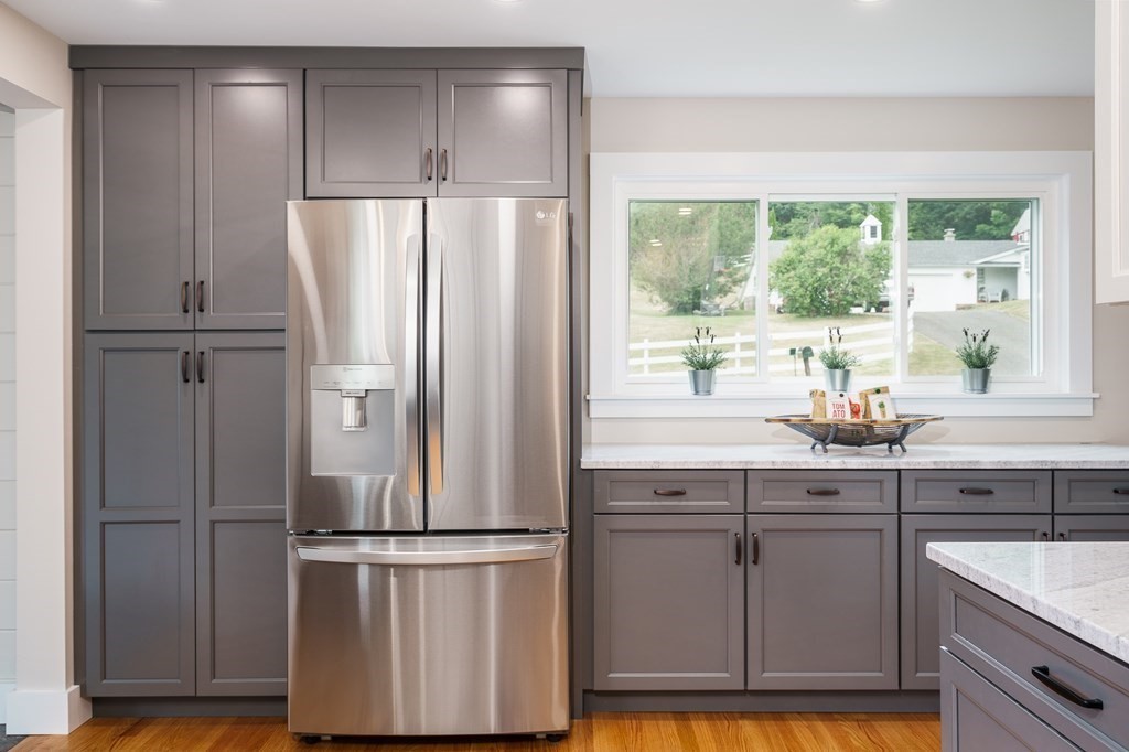 69 High Street Southampton, MA 01073 - Photo 19 of 42 a kitchen with kitchen island a counter top space wooden floor and stainless steel appliances
